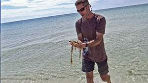 Christian Wagley with Sargasso weed
