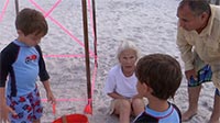 Anne Stuart tells kids about finding and marking a new turtle nest by South Walton Turtle Watch volunteers